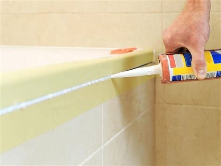 Does silicone stick to grout