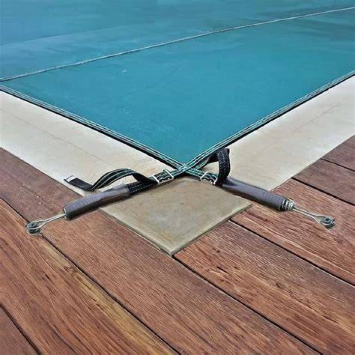 How are pool covers anchored